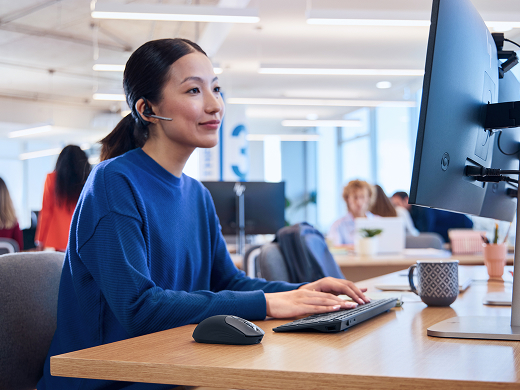 Person working on laptop at an office desk